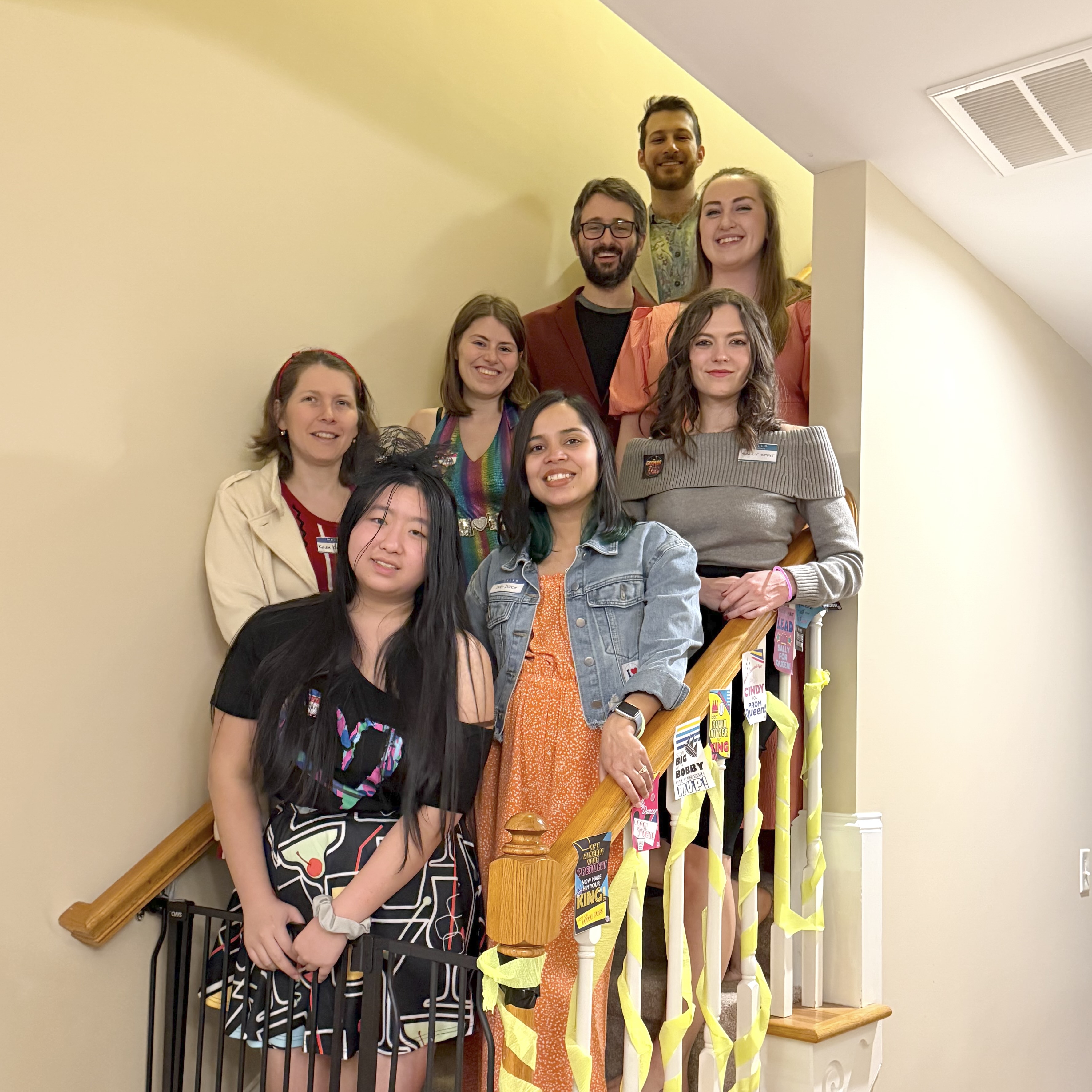 Lab members on the stairs as part of a murder mystery party